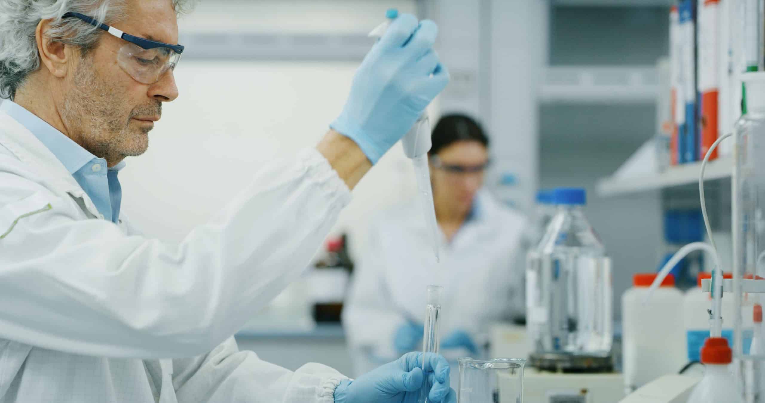 Lab scientists working with pipettes