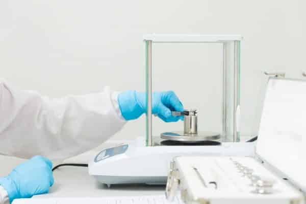 Placing calibration weights on an analytical balance