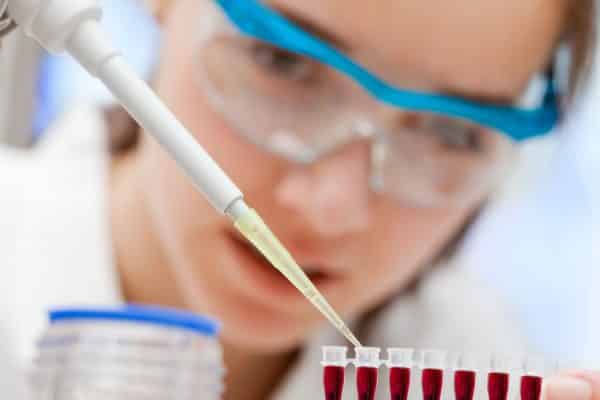 Lab technician performing pipette calibration